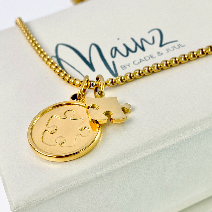 Autismesmykke i guld-look